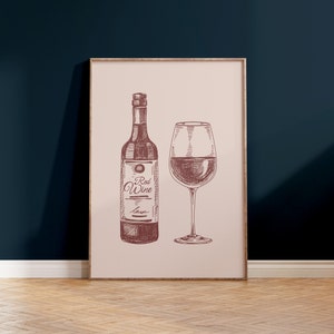 May include: A framed print featuring a detailed sketch of a wine bottle and a wine glass, both filled with red wine. The bottle has a label that reads "Red Wine". The artwork is in shades of brown and is set against a light pink background.