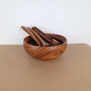 Vintage wooden bowl with utensils