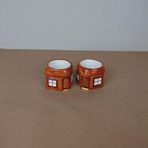 Two ceramic egg cups. House design