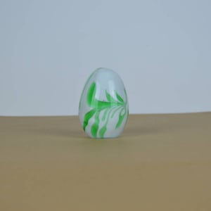 Vintage egg-shaped green and white glass paperweight.