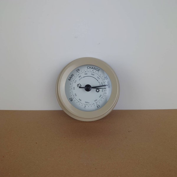 Vintage outdoor barometer. Metal and glass round barometer. Weathermaster, climate checker.