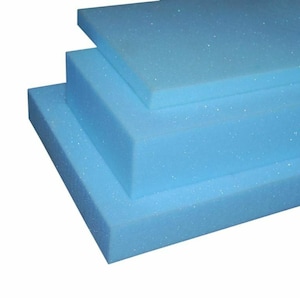 May include: Three pieces of light blue foam padding stacked on top of each other.