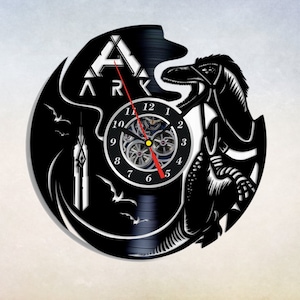 May include: Black vinyl record clock featuring a silhouette of a dinosaur and the word "ARK" in white. The clock face is a circle with black numbers and a red second hand.