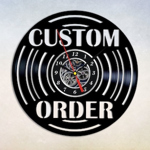May include: Black vinyl record clock with white text that reads "CUSTOM ORDER". The clock face has white numbers and a black clock hand.