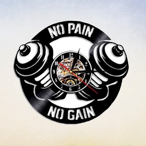 May include: Black vinyl record clock with a dumbbell design and the text "No Pain No Gain".