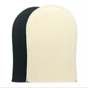 May include: Two tanning mitts, one black and one white, are shown side by side. The mitts are made of a soft, absorbent material and are designed to help you achieve an even tan.