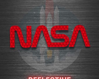 May include: A graphic design featuring the red NASA logo with a geometric triangular pattern overlay. Behind the logo is a faint, ghosted image of a space shuttle launch. The background is a dark, brushed metal texture with the word REFLECTIVE in red.