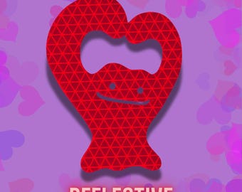 May include: A red, heart-shaped bottle opener with a triangular pattern and a smiling face. The word "REFLECTIVE" is displayed in a light orange font at the bottom of the image. The background is a gradient of purple with heart shapes.