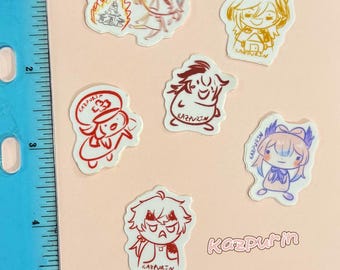 May include: A collection of six small, die-cut vinyl stickers featuring various cartoon character illustrations with the text 'KAZPURIN' on each, displayed next to a blue ruler showing measurements in inches for scale on a light background.