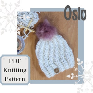 May include: White knitted hat with a cable knit pattern and a pink pom pom. The hat is lying on a wooden surface with yarn and knitting needles. The text "Oslo" is in the upper right corner of the image. The text "PDF Knitting Pattern" is in the lower left corner of the image.
