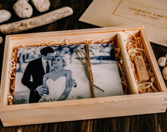 May include: A wooden box with a black and white photo of a couple inside. The box is filled with wood shavings and a small wooden USB drive with the text "secure your memories" engraved on it.