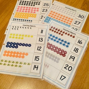 May include: A set of printable counting cards featuring various objects, such as stars, ladybugs, and buttons. The cards are labeled with numbers from 11 to 30.  Counting Objects.