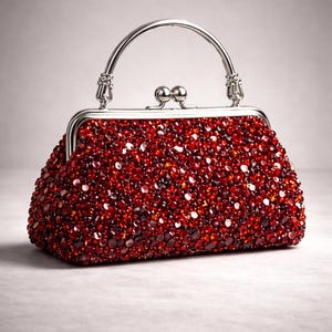 May include: A red beaded handbag with a silver-toned clasp and handle. The bag is covered in small, sparkling red beads, creating a textured surface. The handle arches over the top, and the clasp is a classic kiss-lock style.