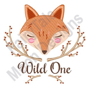 May include: Embroidered design featuring a cute fox with closed eyes and a pink blush, surrounded by brown branches with red berries. The text "Wild One" is written below the fox.