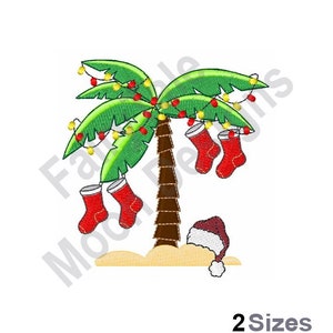 May include: A green palm tree with red and white stockings hanging from the branches. The tree is decorated with yellow Christmas lights. A red Santa hat is on the ground below the tree.