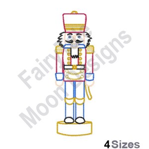May include: A red and blue nutcracker soldier with a gold hat and a white base. The nutcracker is standing on a white base with a gold trim. The nutcracker has a mustache and a black eye.