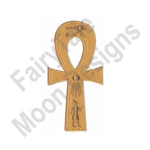 May include: A gold-colored Ankh symbol with intricate embroidered details. The design includes hieroglyphic elements and the text "Fairytale Moon Designs". The Ankh is a cross-like symbol with a loop at the top, often associated with ancient Egyptian culture.