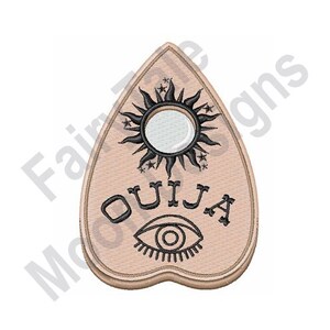 May include: A beige heart-shaped planchette with a black sun and stars design, the word "OUIJA" in black lettering, and a black eye with eyelashes.