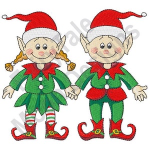 May include: Two smiling elves, one wearing a green dress and the other wearing green pants, both with red hats and white trim. They are holding hands.