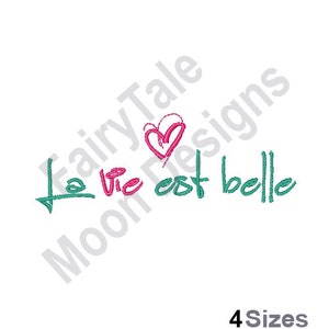 May include: A green and pink embroidery design with the text "La vie est belle" and a heart.