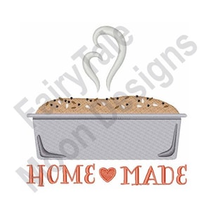 May include: A silver loaf pan with a brown loaf of bread inside. The bread is topped with seeds and has steam rising from it. The text "HOME ♥ MADE" is below the pan in orange.