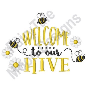 May include: Welcome to our hive embroidery design featuring yellow and black bees, white daisies, and the text "Welcome to our hive" in a yellow script font.