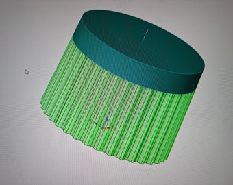 May include: A 3D model of a green and teal lampshade with a fluted design. The lampshade is tilted to the side.