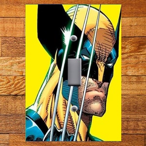 May include: A close-up of Wolverine's face, a comic book character with sharp claws and a yellow background. The image is designed for a light switch cover.