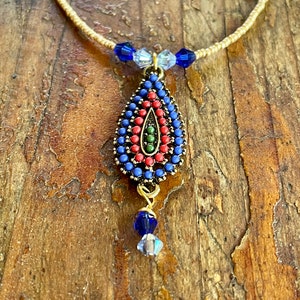 Global Teardrop Zola Elements antique gold focal charm with cobalt and light blue crystals on tiny gold seed beads with gold filled toggle