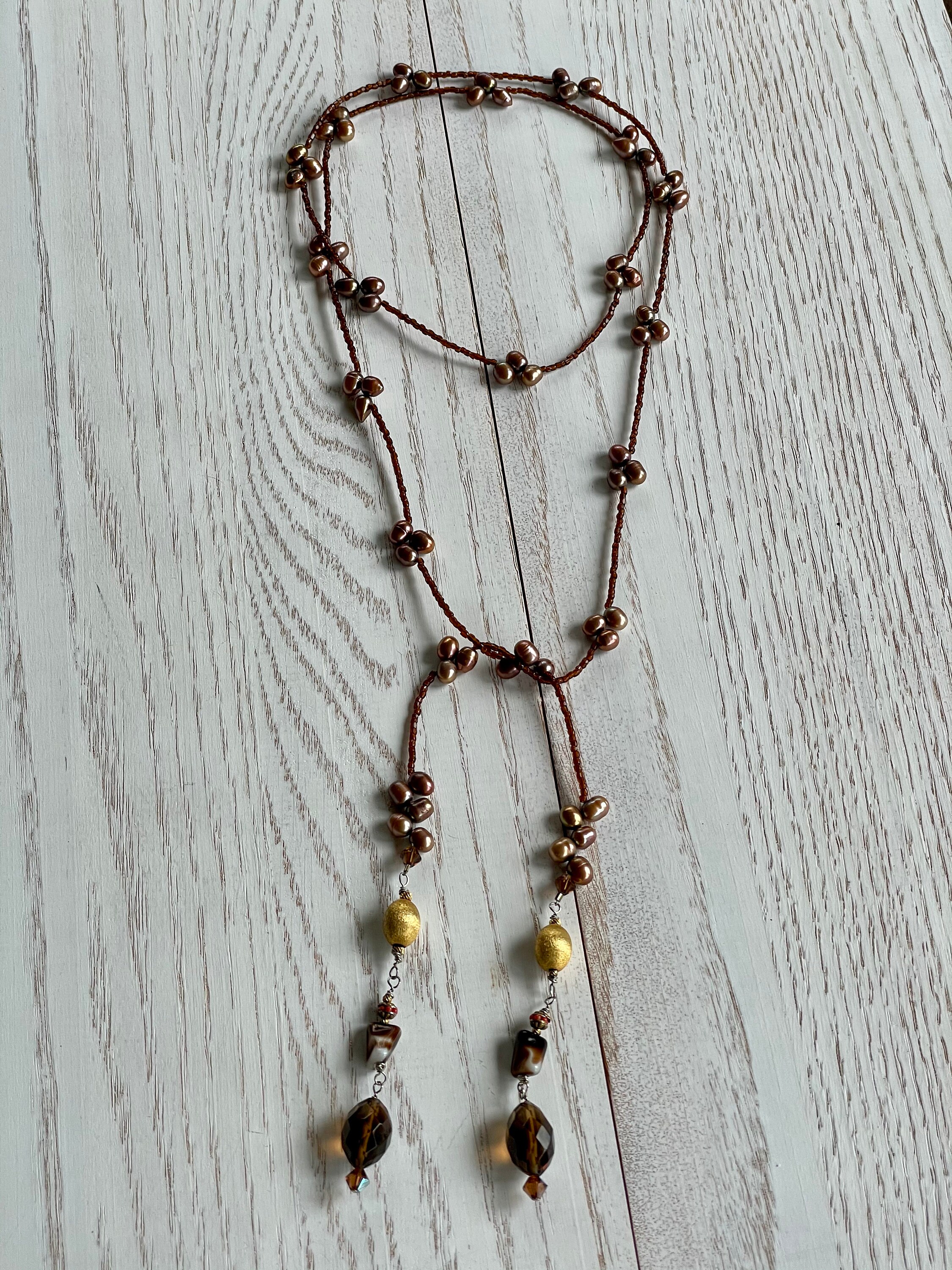 and dangles of black onyx round and Rhodonite nugget Lariat wrap necklace with chili colored diagonally drilled pearls gray seed beads