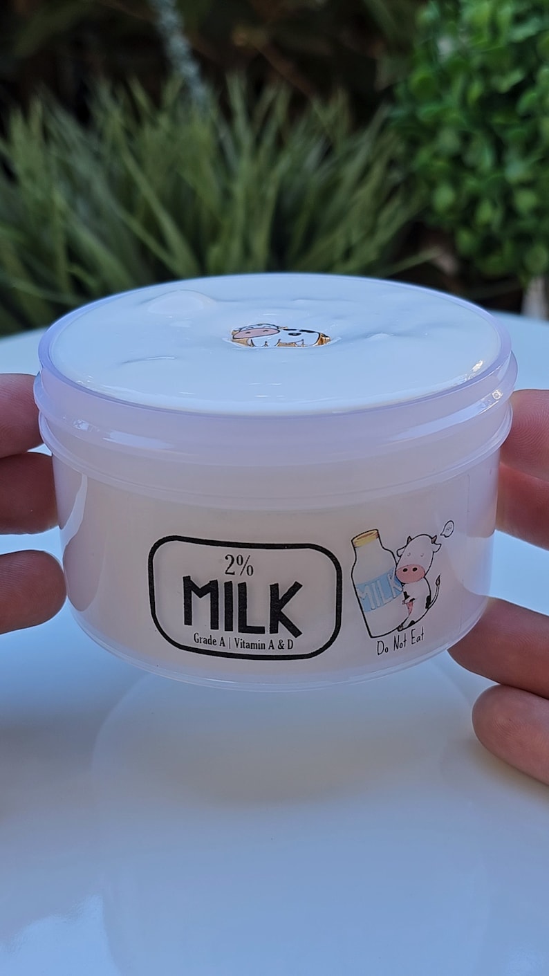 May include: A white plastic container of 2% milk with a cartoon cow and milk carton on the label. The label reads "2% Milk", "Grade A", "Vitamin A & D", and "Do Not Eat".