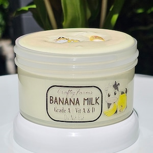 May include: A white jar of banana milk slime with a cartoon cow and banana on the label. The label reads "Crafty Farms Banana Milk Grade A | Vit A & D Do Not Eat".