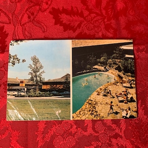 May include: Vintage postcard with two images. One shows a building with a grassy area and cars. The other depicts a swimming pool with people swimming and sunbathing on a stone patio. The postcard is on a red background.