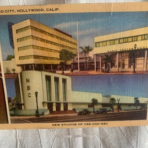 May include: A vintage postcard depicting the new studios of CBS and NBC in Hollywood, California. The postcard shows two buildings, one with the text "RADIO CENTER WEST" and the other with the text "NBC".
