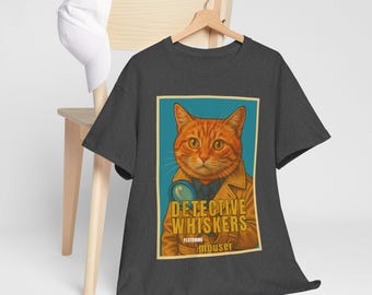 May include: Dark grey t-shirt with a cartoon image of an orange tabby cat dressed as a detective, holding a magnifying glass. The text "DETECTIVE WHISKERS" and "featuring mouser" are printed on the shirt.