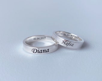 May include: Two silver wedding bands with the names "Diana" and "Hafez" engraved on them, along with the date "01.04.2019".