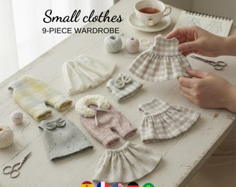 May include: A 9-piece wardrobe set of small doll clothes including dresses, skirts, and tops in various neutral colors like beige, white, gray, and pink with plaid and dotted patterns. The text "Small clothes 9-PIECE WARDROBE" is visible.