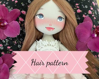 May include: A fabric doll with long brown hair, blue eyes, and rosy cheeks, wearing a white lace-trimmed dress. The doll is positioned against a black floral background with purple orchid petals. A pink banner displays the text Hair pattern.