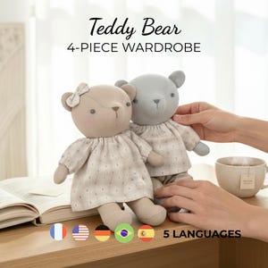 May include: Two plush teddy bears, one tan and one gray, dressed in matching outfits. The tan bear has a bow. The text "Teddy Bear 4-PIECE WARDROBE" is displayed above the bears. A cup of tea and an open book are also visible.