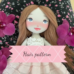 May include: A fabric doll with long brown hair, blue eyes, and rosy cheeks, wearing a white lace-trimmed bodice and a layered light pink skirt. A pink banner with the text "Hair pattern" is overlaid across the center of the doll's torso.