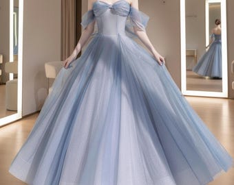 May include: A light blue formal gown with a sweetheart neckline and spaghetti straps. The bodice features a bow detail, and the off-the-shoulder sleeves add a touch of elegance. The skirt is full and flowing, creating a graceful silhouette.