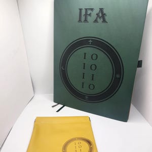 May include: A green book with the letters "IFA" and a circular design with the numbers "10110". A yellow pouch with a matching circular design is in front of the book. The book and pouch are on a white surface.