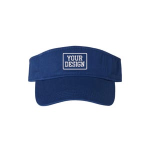 May include: A navy blue visor with a curved peak. The visor features a rectangular patch with the words "YOUR DESIGN" in white block letters. The visor is made of a soft, durable material.
