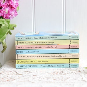 May include: A stack of eight paperback books with colorful covers. The titles include "Fairy Tales", "What Katy Did", "Alice in Wonderland", "Heidi", "The Secret Garden", "Black Beauty", and "A Little Princess". Each book has a "Parragon" logo on the spine.