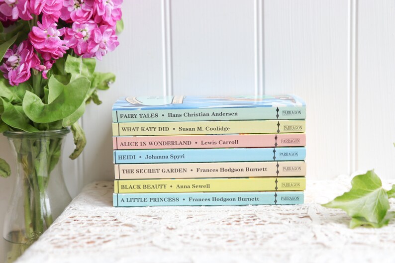 May include: A stack of eight paperback books with colorful covers. The titles include "Fairy Tales", "What Katy Did", "Alice in Wonderland", "Heidi", "The Secret Garden", "Black Beauty", and "A Little Princess". Each book has a "Parragon" logo on the spine.