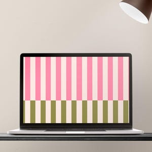 May include: A laptop displays a colorful striped pattern. The top half features alternating pink and off-white vertical stripes, while the bottom half has green and off-white stripes. A brown desk lamp is positioned above the laptop.