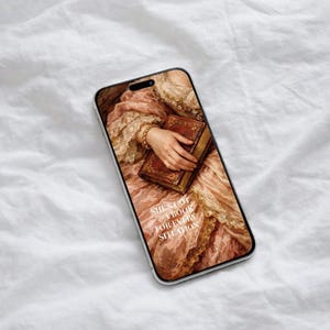 May include: A phone case displaying a vintage painting of a person holding a book. The artwork is in pink, brown, and gold tones, with the text "SHE'S GOT A BOOK FOR EVERY SITUATION". The case has a clear border.