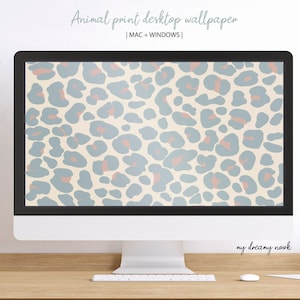 May include: A desktop computer displays an animal print wallpaper. The wallpaper features a pattern of blue and coral-colored spots on a cream background. The text "Animal print desktop wallpaper" is at the top, with "MAC + WINDOWS" below it.