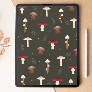 May include: A digital tablet shows a repeating pattern of mushrooms in shades of brown, red, and white on a dark green background. The design includes stylized leaves and small yellow dots. A white stylus rests on a brown surface.