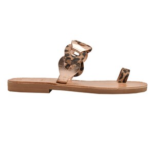 May include: A single sandal with a brown sole and a rose gold upper. The upper features a chain design with a leopard print accent. The sandal has a toe loop with a leopard print.